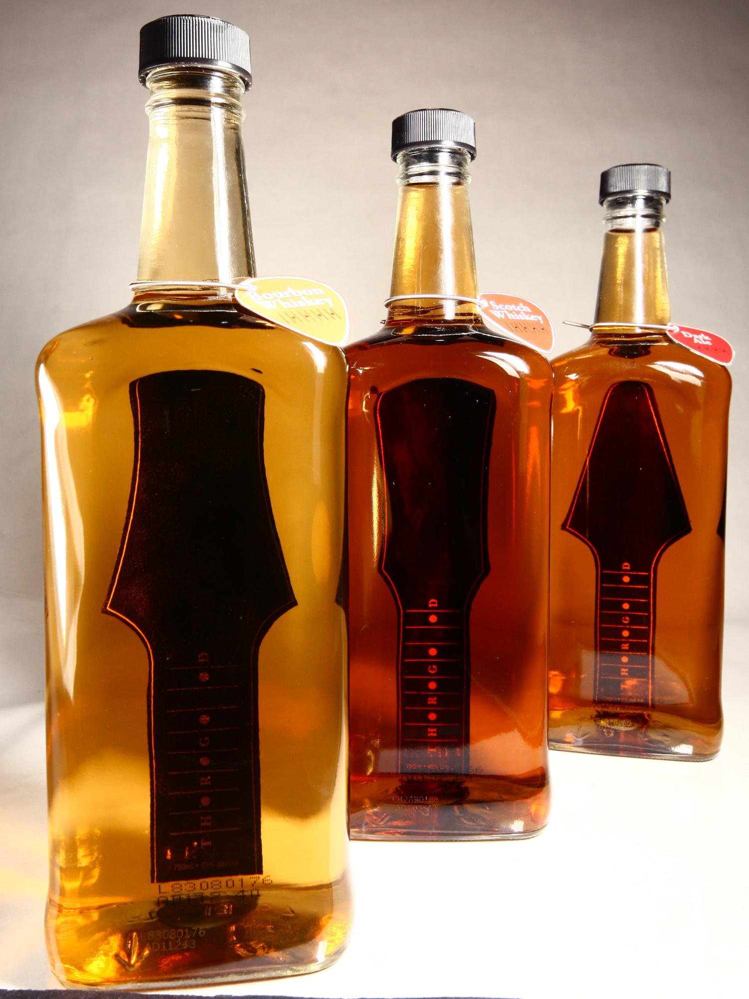 A photo of 3 bottles of whiskey 